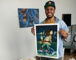 Anthony Peyton Young holding his print, Candlelight Vigil in his studio