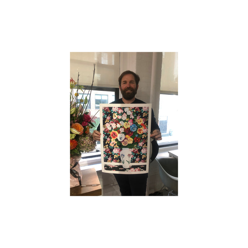 Alec Egan holding up the signed and numbered, unframed print, Flowers on Flowers